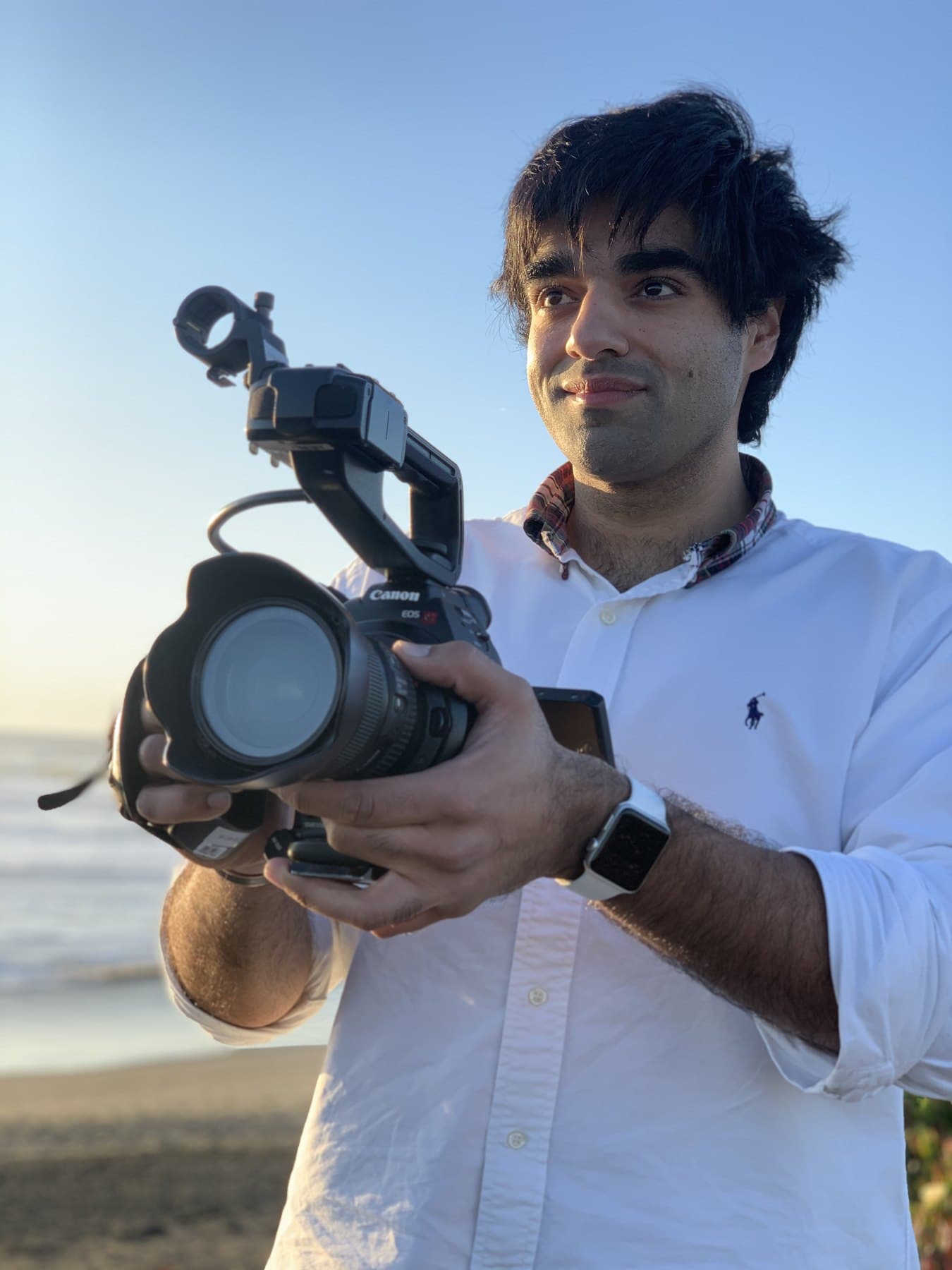 Arjan Singh Puniani holding a camera outdoors