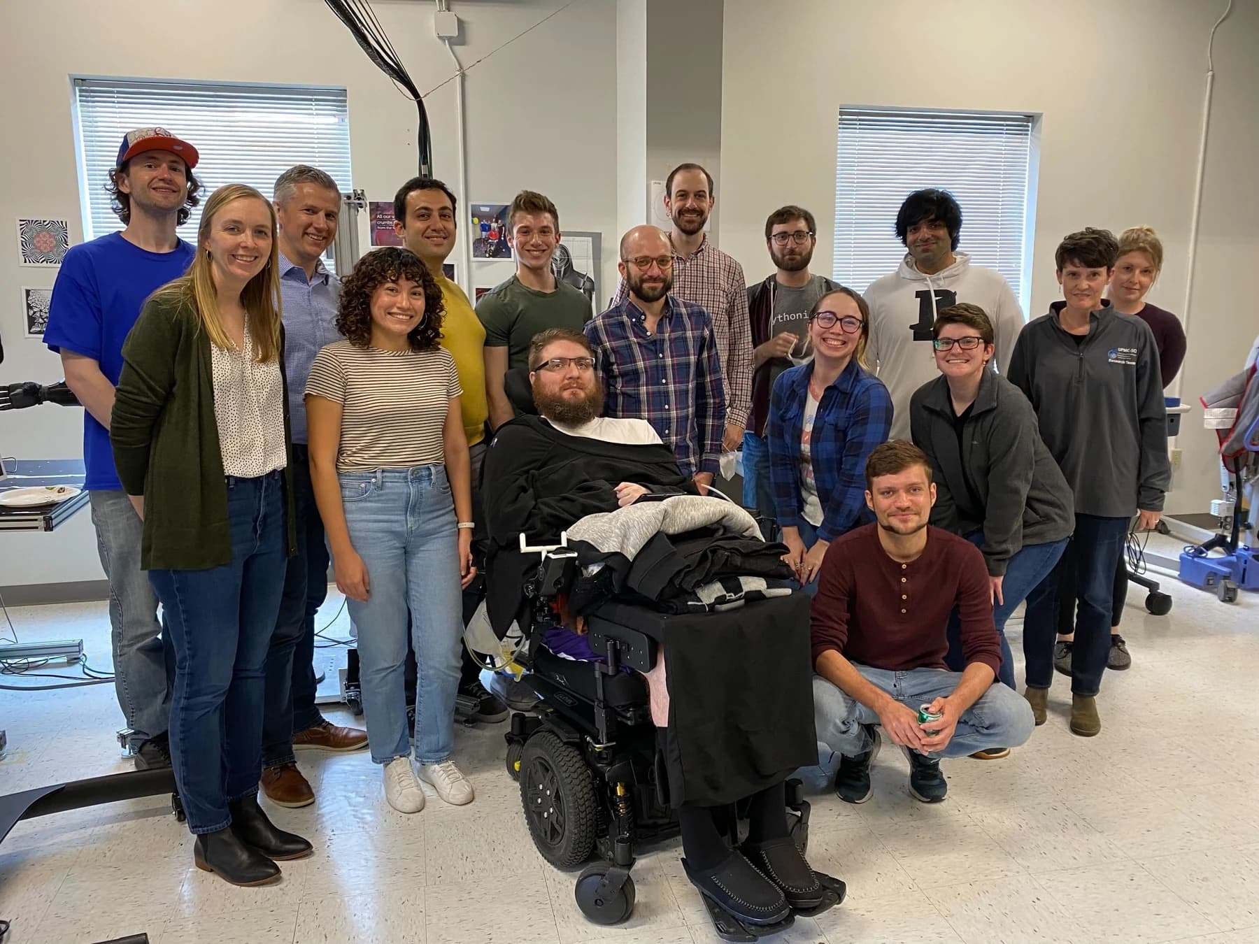 Rehab Neural Engineering Labs research team gathered around a participant in the laboratory